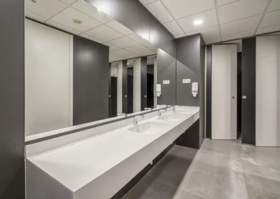 Lavabos y cabinas fenólicas oscuras en las oficinas de Endesa